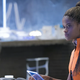 Letitia Wright's Princess Shuri looks up from a computer monitor in her tech lab in a scene from Black Panther.